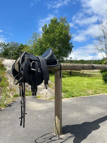 a black bag hanging on a wooden fence at Annas gård, stall & pensionat in Fjärås