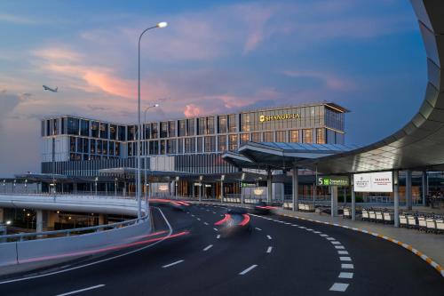 a car driving down a road in front of a building at Shangri-La Hongqiao Airport,Shanghai in Shanghai