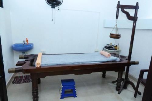 a hospital room with a bed and a sink at Broad Bean Royal Resort Goa in Canacona