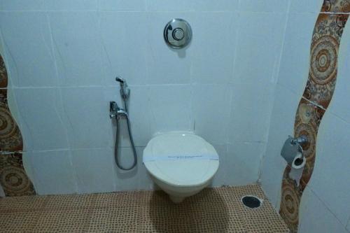 a bathroom with a toilet and a shower at Broad Bean Royal Resort Goa in Canacona