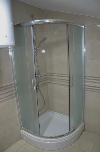a shower with a glass door in a bathroom at Apartment Drazan in Šibenik