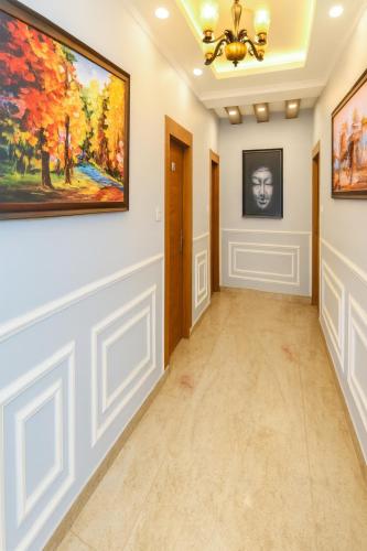 a hallway with a painting on the wall at Hotel Pawan Regency- Best Mountain View Hotel In McLeodganj in McLeod Ganj