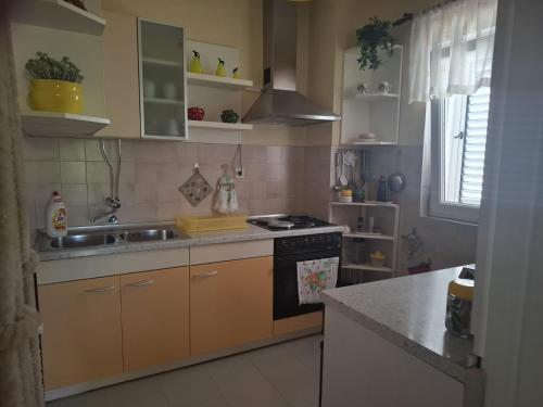 a kitchen with a sink and a stove at Zvjezdana in Kampor