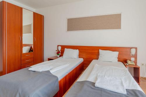 Ένα ή περισσότερα κρεβάτια σε δωμάτιο στο Triple M Hotel