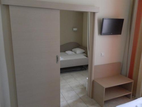 a small room with a bedroom with a bed at Esperia in Thessaloniki