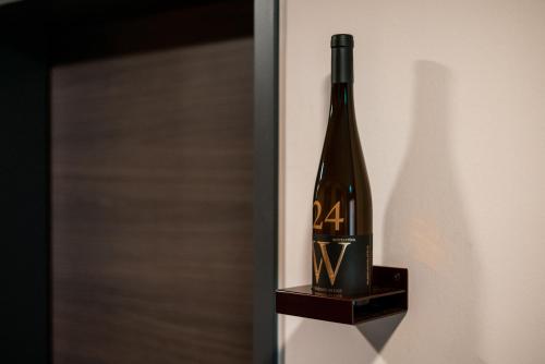 a bottle of wine sitting on a shelf at Weinhotel Wasem in Ingelheim am Rhein
