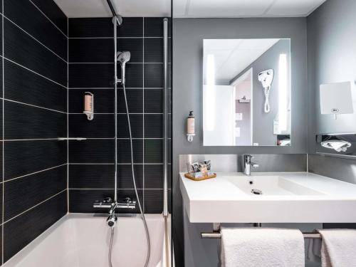 a bathroom with a shower and a sink at Mercure Compiègne Sud in Compiègne