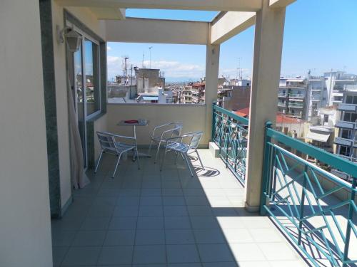 a balcony with chairs and a table on it at Esperia in Thessaloniki