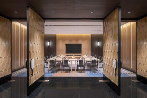 a conference room with a long table and chairs at Traders Hongqiao Airport,Shanghai in Shanghai