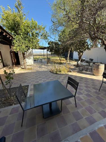 a table and chairs sitting on a patio at Boutique Hotel Bodega CICLO ANDINO in Perdriel