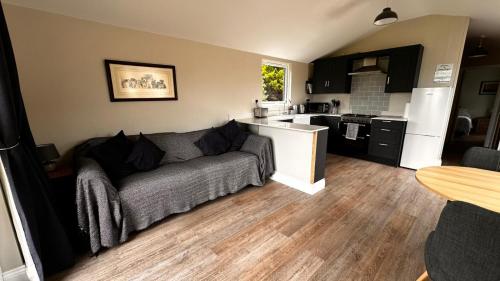 a living room with a couch and a kitchen at Entick Lodge No 4 in Dunswell