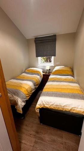 two beds sitting next to each other in a room at Entick Lodge No 4 in Dunswell