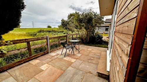 a patio with a table and chairs and a fence at Entick Lodge No 4 in Dunswell