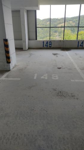 an empty parking lot in a building with windows at Snow peak Wellness & Spa, Kopaonik Milmari N5 in Kopaonik