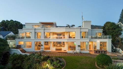 a large white house with a lot of windows at SEASENSE Boutique Beach Villa in Wilderness