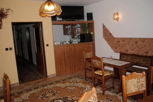 a dining room with a table and a mirror at Pension B&B in Vrchlabí