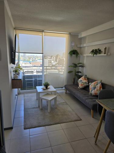 a living room with a couch and a table at Cálido -moderno - céntrico - acogedor - in Rancagua