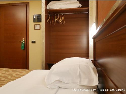 Una cama o camas en una habitación de Hotel La Pace - Experience