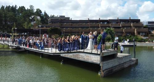 a group of people standing on a bridge over the water at Lakepark Residence in Staré Splavy