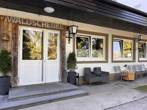 a building with a white door with a sign on it at Appartement Wolke7 byTILLY - Im Skigebiet Gerlitzen auf 1500m Seehöhe - familienfreundliche 3 Zimmer Wohnung - Hallenbad im Haus - moderne Küche mit Vollausstattung - Balkon - traumhafte Aussicht über ganz Kärnten - himmlisch bequeme Boxspringbetten in Treffen