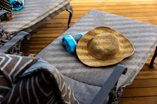 a straw hat sitting on top of a table at SEASENSE Boutique Beach Villa in Wilderness