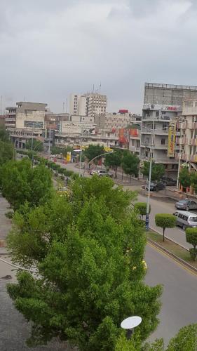 a city with buildings and a street with trees at Dijlat Al Khair Hotel فندق دجلة الخير in Baghdad