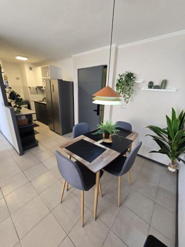 a dining room with a table and chairs and a kitchen at Departamento centro in Rancagua
