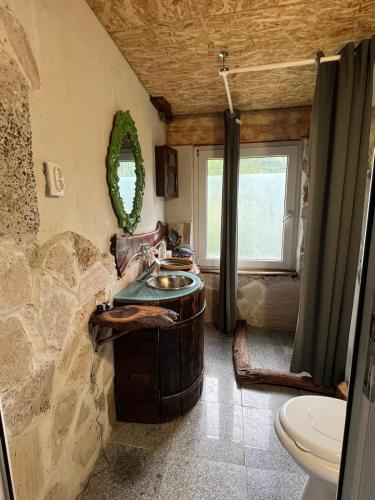 a bathroom with a wooden barrel sink and a toilet at Stillwood Retreat-Off-Grid Nature Escape in Certeju de Jos