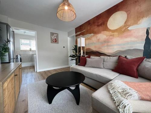 a living room with a couch and a table at Stunning and Peaceful 2 bed Flat 10 mins from Stansted Airport in Stansted Mountfitchet