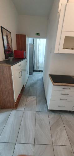 a kitchen with white cabinets and a tile floor at Affordable 5-BR Shared Apartment / Enkplatz U3 Getaway in Vienna
