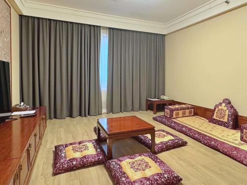 a living room with two chairs and a table at Novotel Ambassador Seoul Gangnam in Seoul