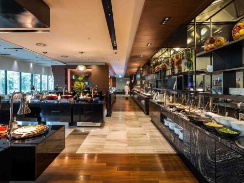 a restaurant with a buffet line of food at Novotel Ambassador Seoul Gangnam in Seoul