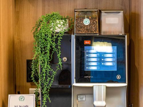 a vending machine with plants on top of it at Novotel Ambassador Seoul Gangnam in Seoul