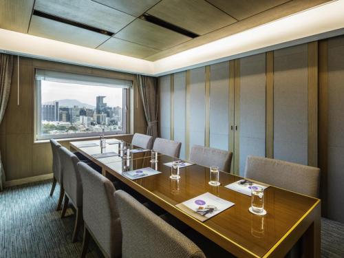 a conference room with a long table and chairs at Novotel Ambassador Seoul Gangnam in Seoul