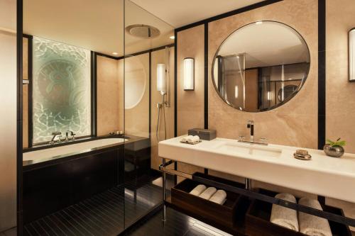 a bathroom with a sink and a mirror at Bvlgari Hotel Paris in Paris