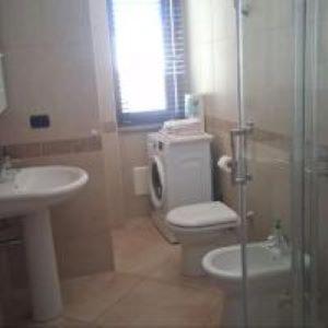 a bathroom with a toilet and a sink and a shower at Zostera Apartment in Melito di Porto Salvo