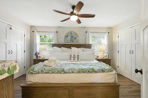 a bedroom with a bed with a ceiling fan at The Holiday House w Dock in Townville