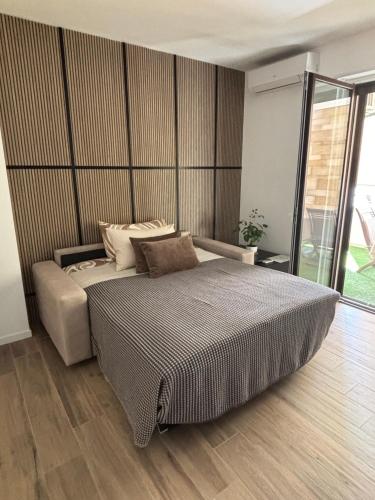 a bedroom with a large bed in a room at B&B Bari Apartment by Margi in Bari