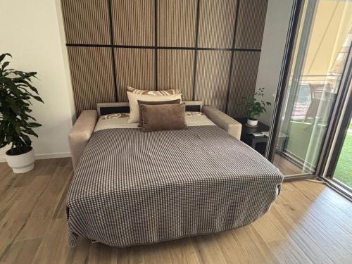 a bed with pillows on it in a room at B&B Bari Apartment by Margi in Bari