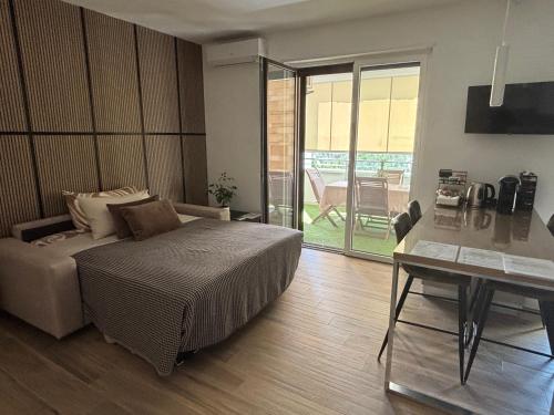 a bedroom with a bed and a desk and a table at B&B Bari Apartment by Margi in Bari