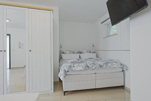 a white bedroom with a bed and a walk in shower at Smart-Apartment in Bamberg in Bamberg