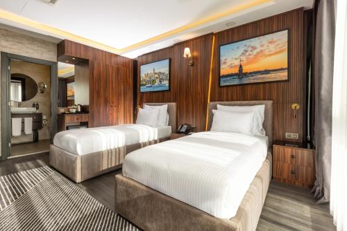 a bedroom with two beds and a bathroom at La Quinta By Wyndham Istanbul Kartal in Istanbul