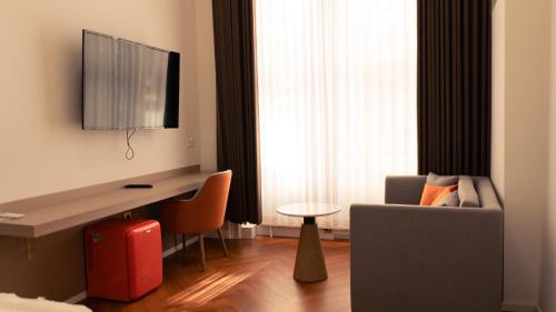 a living room with a desk and a couch and a chair at Elias Residence Vienna in Vienna