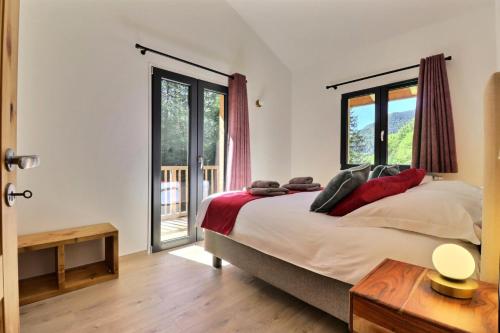 a bedroom with a bed and a large window at Chalet D'ardent - Chalet D'Ardent - 8/10 personnes - Montriond MAE-0493 in Montriond