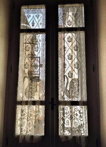 two stained glass windows in a room at Aghinas in Bosa
