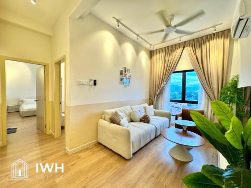 a living room with a couch and a table at Ipoh Horizon Skypool Town Suites 4-11pax by IWH Suites in Ipoh
