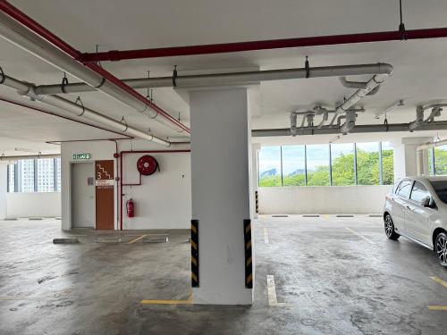 a parking lot with a car parked in it at Ipoh Horizon Skypool Town Suites 4-11pax by IWH Suites in Ipoh