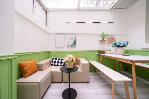 a living room with a couch and a table at 柃居 B&B - Jing'an Temple Branch in Shanghai