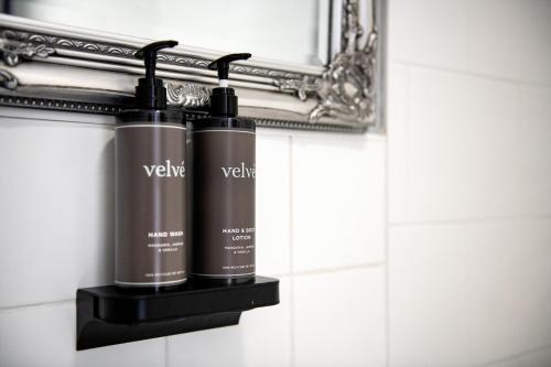 a couple of bottles on a wall in a bathroom at The Royal Oak in Hawkhurst
