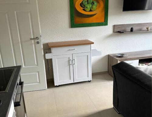 a kitchen with a white cabinet in a room at Ferienwohnung Linus OG 95172 in Rhauderfehn